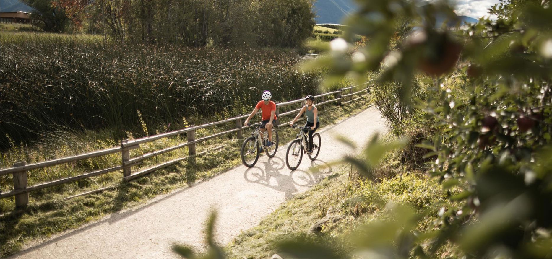 Two people are riding bicycles