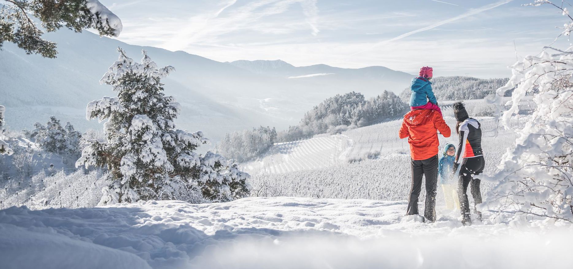 A family is hiking in the snow