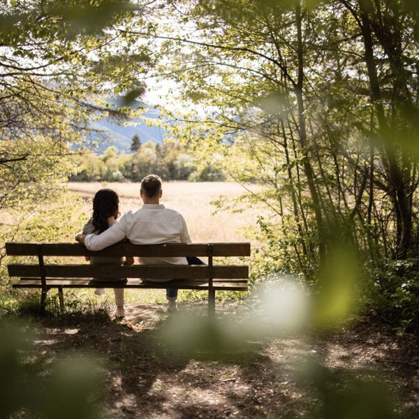 A man and a woman take a break in the forest